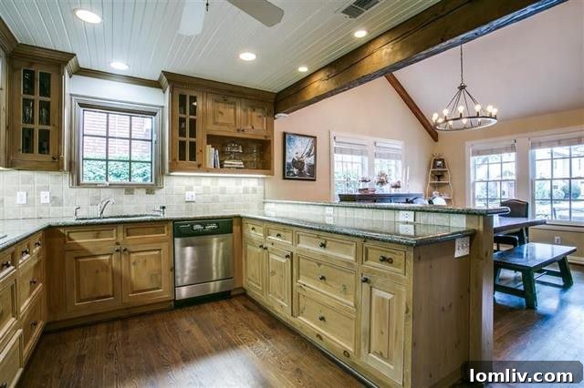 Inviting dining room with hardwood floors and a beamed ceiling, open to the kitchen.