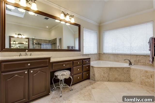 Luxurious spa-quality master bathroom showcasing a deep soaking tub and separate glass-enclosed shower