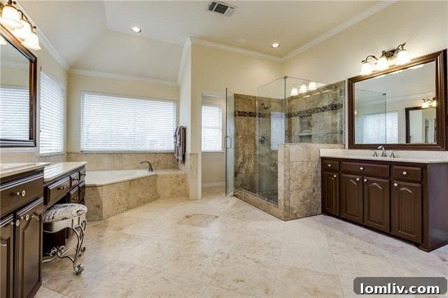 Elegant dual vanity with ample counter space and designer fixtures in the master bathroom