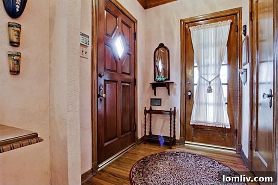Hollywood Heights Tudor: A Designer's Vision Realized 3 Original entryway of 707 Cordova Street before the renovation, showing dated finishes and potential.