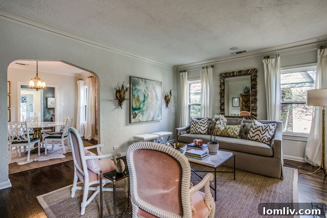 Hollywood Heights Tudor: A Designer's Vision Realized 8 Interior view of the sophisticated living area with elegant furnishings and a cozy fireplace, post-renovation at 707 Cordova.