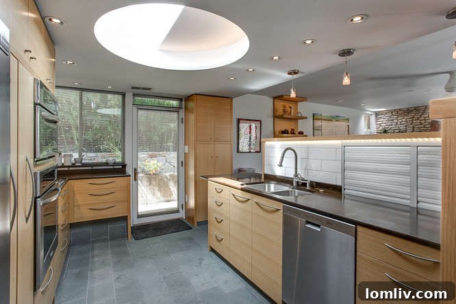 Modern kitchen with custom cabinetry and PaperStone countertops in a LEED townhome
