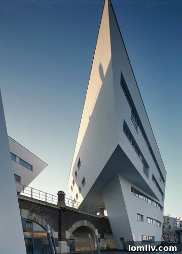 Architectural detail of Spittelau Viaducts Housing showing the striking modern façade against the historic arches.