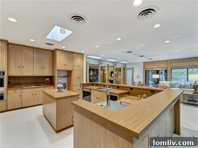 Main kitchen with floor-to-ceiling blond wood cabinets and casual sitting area