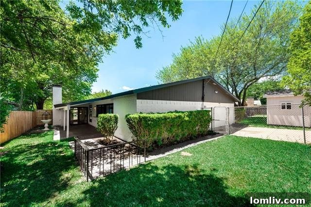Side View of Renovated Home with Green Lawn