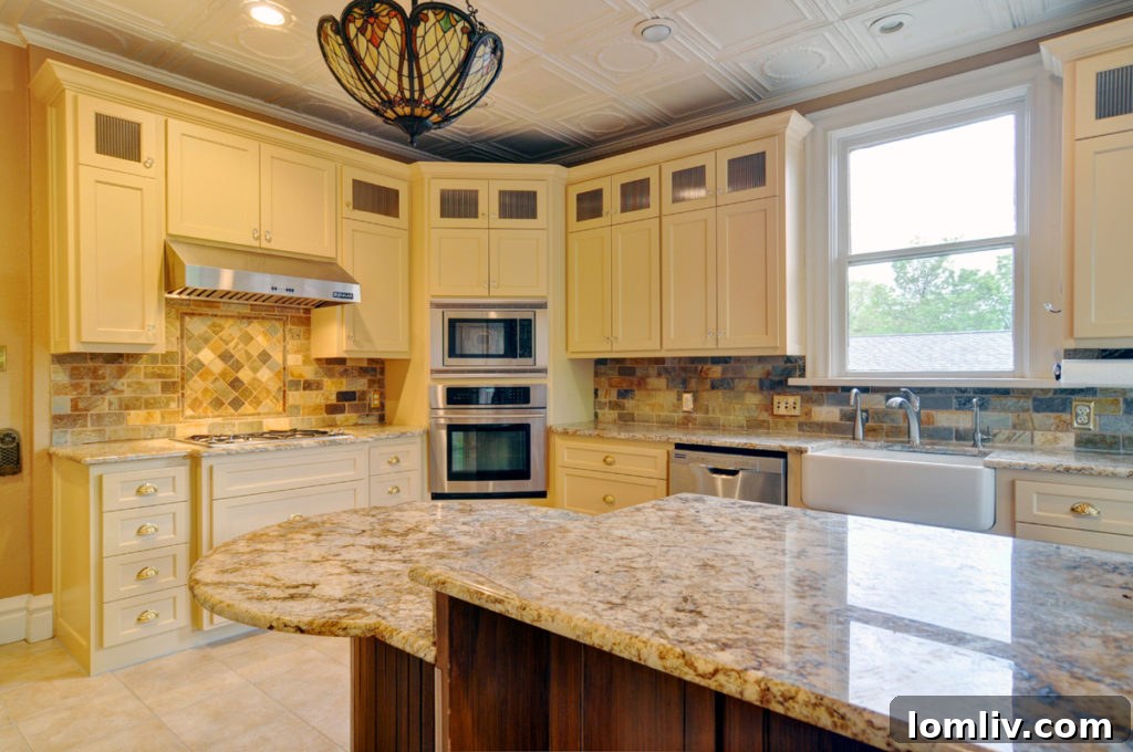 Another view of the updated kitchen with a charming tin ceiling