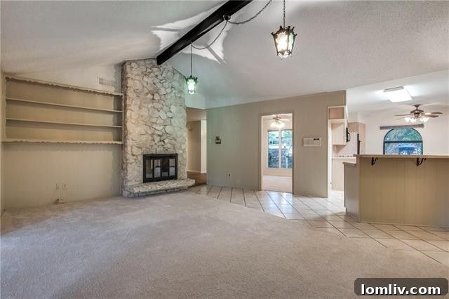 Close-up of the impressive floor-to-ceiling stone fireplace, a focal point in the spacious family room of this ranch home.