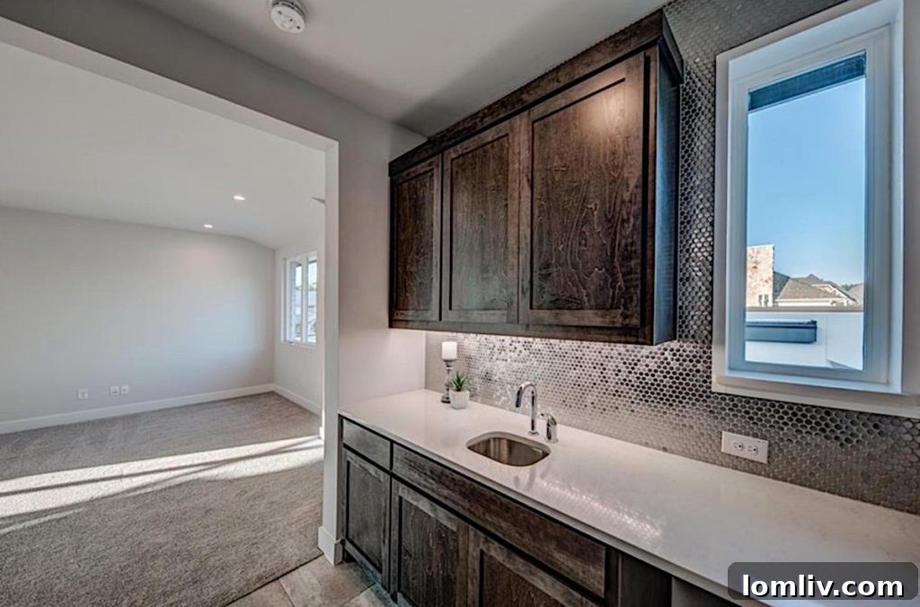 Luxurious Upstairs Game Room with Integrated Kitchenette and Penny Tile Backsplash