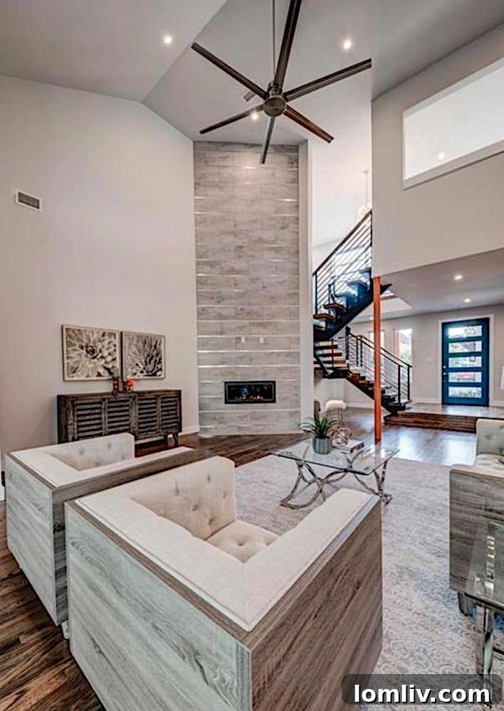 Dynamic Entrance with Floating Staircase and Double-Height Fireplace in Midcentury Modern Home