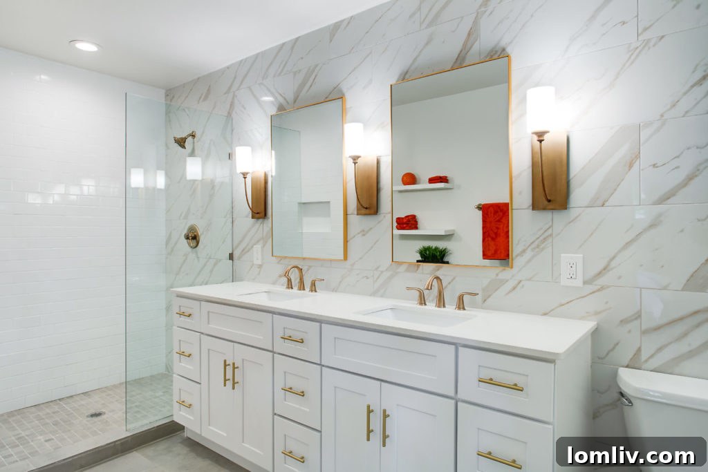 Elegant Master Bathroom with Gold Fixtures and Frameless Glass Shower