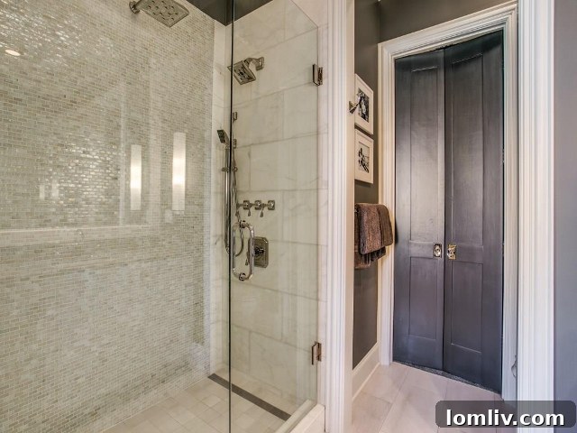 Spa-like full bath with shimmering tile and modern fixtures.