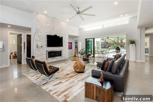 Spacious central living room with large sliding glass doors opening to outdoor patio and pool