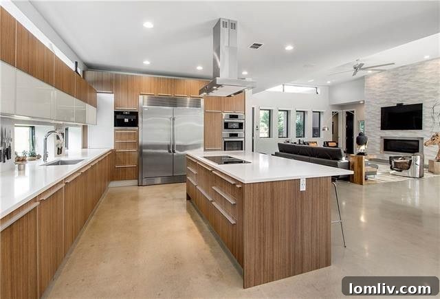 Modern kitchen with touchless faucet, electric cabinets, large island, and ample storage
