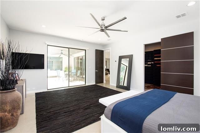 Luxurious master bedroom with barn door closet and access to outdoor patio and pool