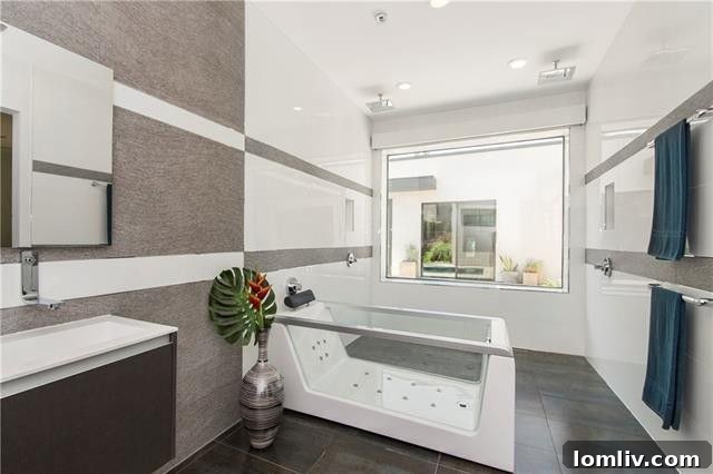 Sleek master bathroom with a unique transparent Barbarella-style bathtub and open shower