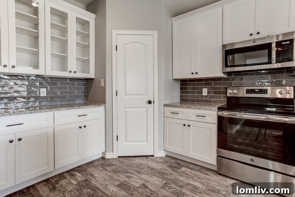 Modern kitchen at 2008 Shane Avenue with wood tile floor, granite counters, and trendy backsplash for $234,990.