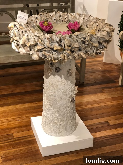 A birdbath with oyster shell accents at Currey & Company