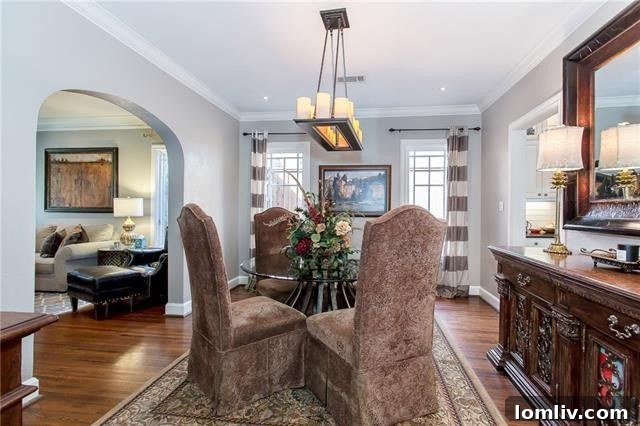 Spacious living room with original archways and hardwood floors