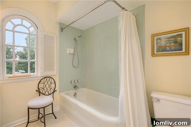 Master bathroom with serene spa-blue tiles and an elongated vanity