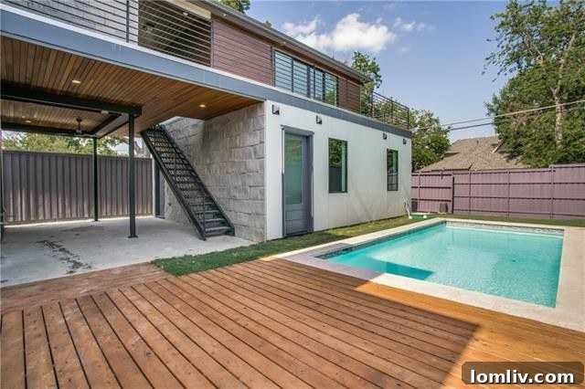 Outdoor patio with sparkling swimming pool and an equipped outdoor kitchen, ideal for entertaining
