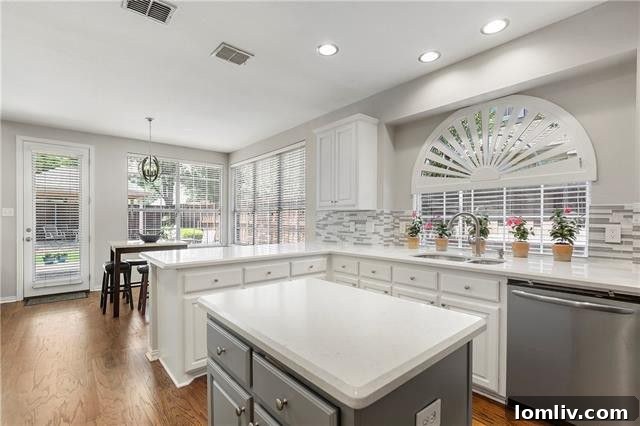 Modern Kitchen with Quartz Countertops and Glass Front Cabinets