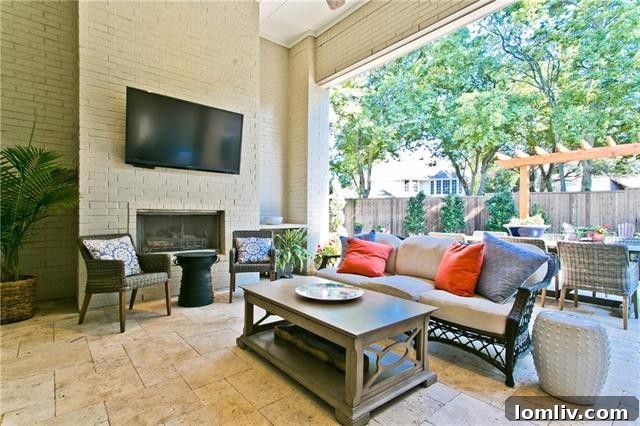 Outdoor Living Space with Fireplace and Built-in Grill in Allen Home