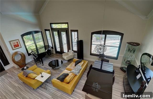 Inviting Living Area with High Ceilings and Abundant Natural Light