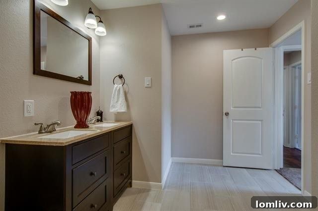 Modern Bathroom Vanity with Dual Sinks and Contemporary Faucets at 9659 Leaside Dr.