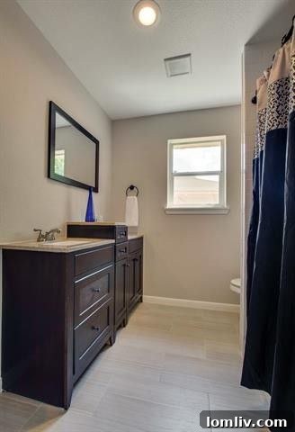 Detail of Custom Tile and Frameless Shower Door in Master Bath at 9659 Leaside Dr.