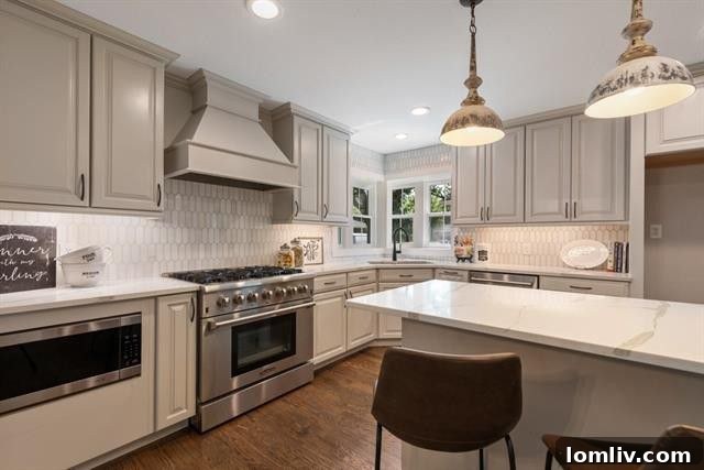 Modern kitchen featuring Calcutta quartz countertops and commercial-grade appliances