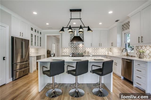 Kitchen featuring white marble countertops, custom inset cabinets, and Bertazzoni appliances