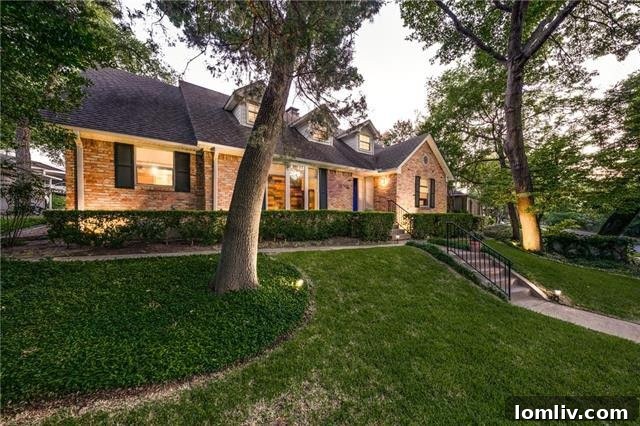 Charming Exterior of 10566 Creekmere Drive with Dormer Windows and Lush Landscaping