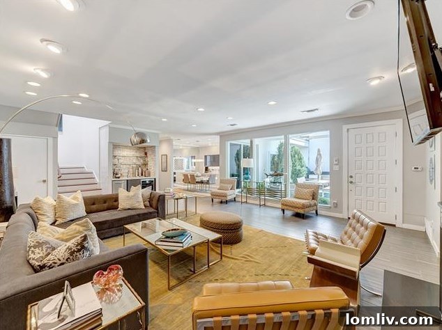Bright, open living room with blonde hardwood floors and a fireplace at 5535 El Campo