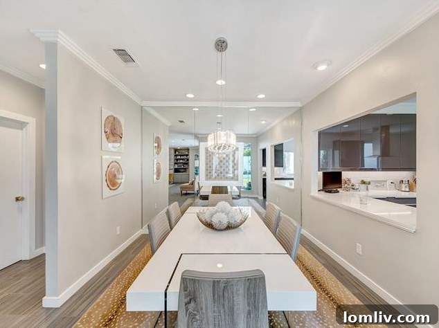 Modern kitchen with slick cabinetry, white quartz countertops, and an induction cooktop