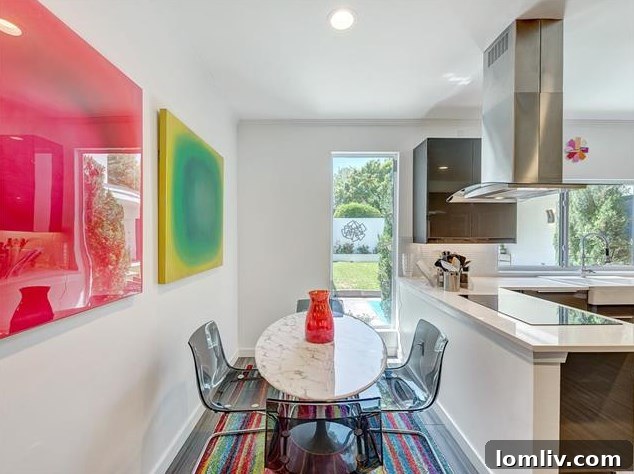 Sleek induction cooktop with an overhead industrial vent in the renovated kitchen