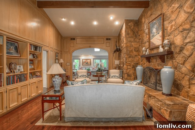 Elevated ceilings in the family room with stone wall make this home very inviting