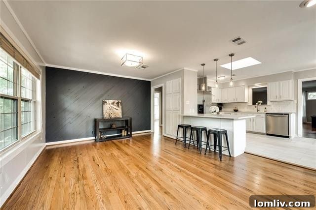 Welcoming living room with gleaming hardwood floors, abundant natural light, and tasteful built-in shelving at 617 Cliffdale Avenue, Oak Cliff