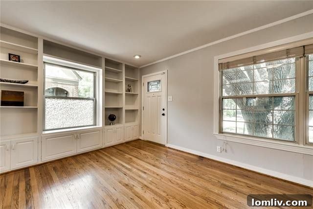 Bright and spacious living area with gleaming hardwood floors and ample natural light in this renovated El Tivoli Place home
