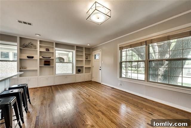 Modern kitchen with crisp white cabinets, subway tile backsplash, and stainless steel appliances at 617 Cliffdale Ave, showcasing the breakfast bar