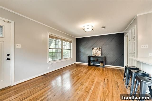 Cozy bedroom with pristine hardwood flooring, neutral decor, and ample natural light in the renovated El Tivoli Place residence