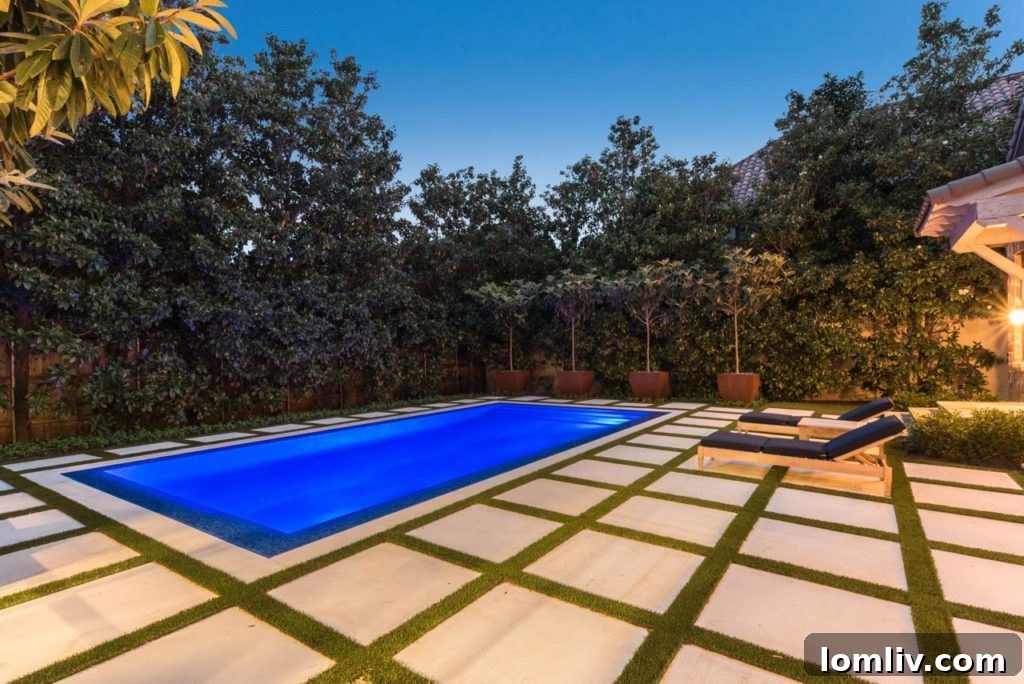 Modern luxury pool with a pristine water surface and surrounding minimalist landscape design by Harold Leidner Landscape Architects.