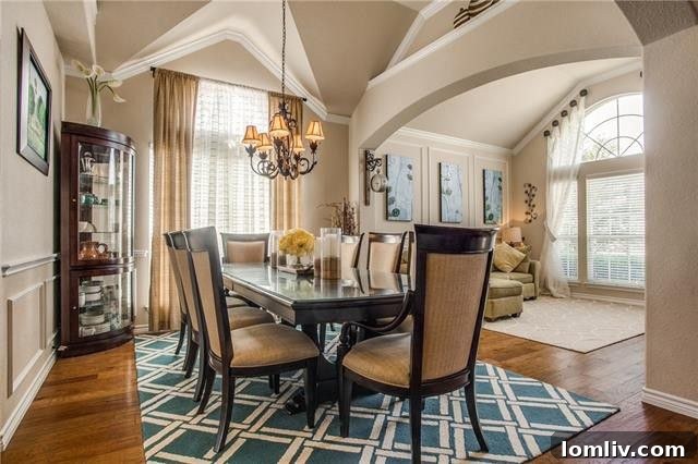 A spacious and inviting living room featuring a focal stone fireplace, perfect for family gatherings