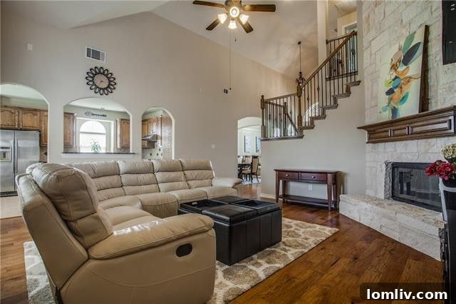 A modern, highly functional kitchen with a large central island, gleaming granite countertops, and sleek stainless steel appliances