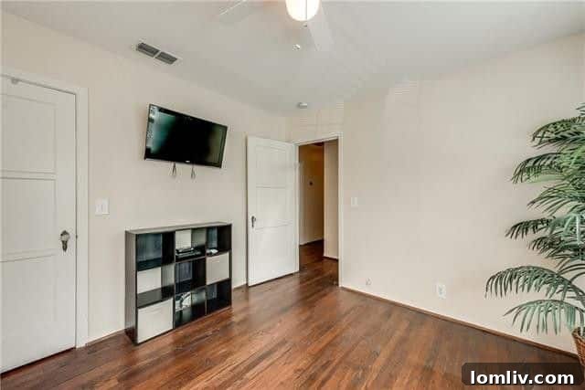 Bedroom with hardwood floors and bright windows