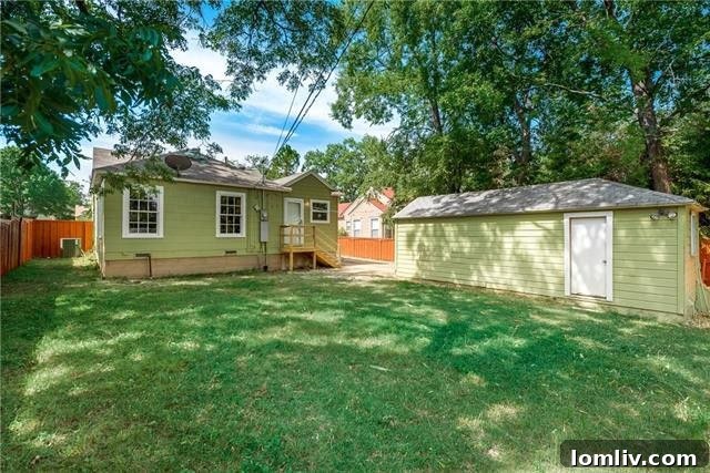 Backyard view with privacy fence and lush greenery