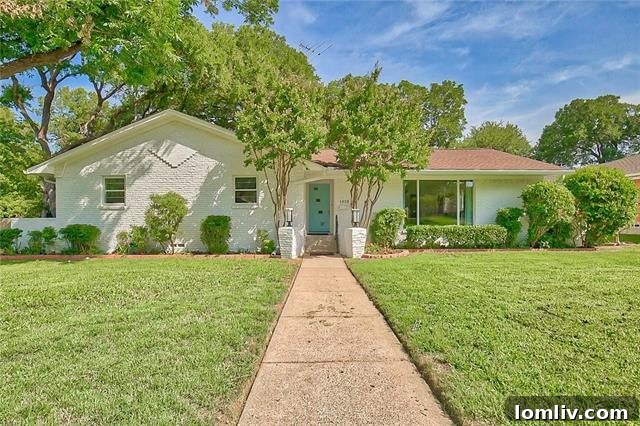 Luxurious Casa Linda Dallas home exterior with white brick and retro sea blue door