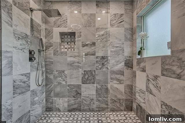 Vanity area in the master bathroom showcasing marble countertops and ample lighting