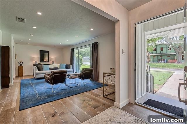 Spacious living area showcasing high-end finishes and custom lighting