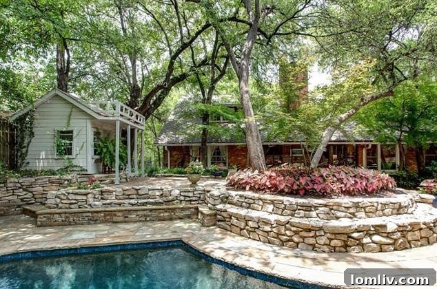 Multi-level backyard gardens with expertly crafted hardscaping, raised beds, and lush plantings at 208 Rockwood Drive.