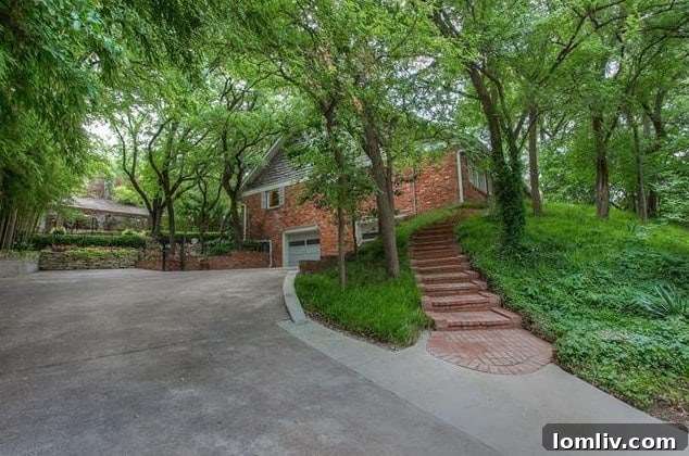 Elegant brick steps leading to the entrance of the split-level home at 208 Rockwood Drive, framed by lush greenery.